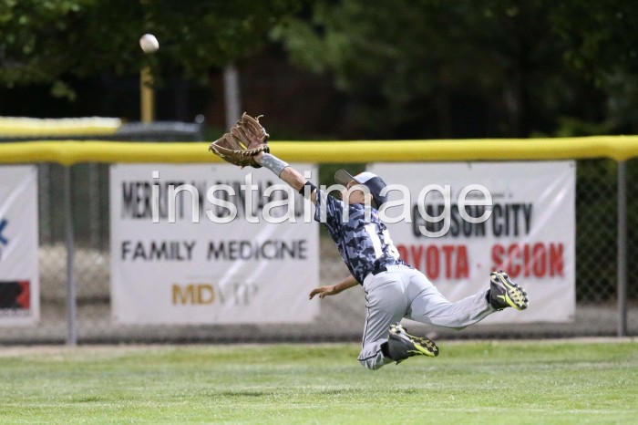 Carson Valley Little League 11 year old Right Fielder dives for a fly ball to right center during their game against Washoe Little League in tonight's opening game of the 2014 Nevada District 1 Little League Tournament at Governor's Field in Carson City, NV