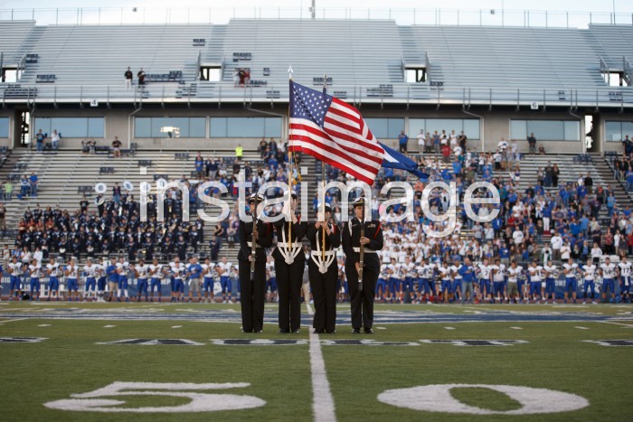 Carson High Navy Jr. ROTC members display the colors before the game.